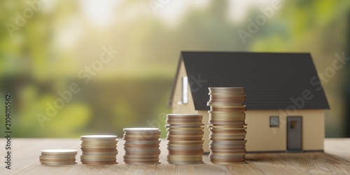 Miniature model house with rising money coins bar graph on wooden table over garden background, home or property investment concept, selective focus