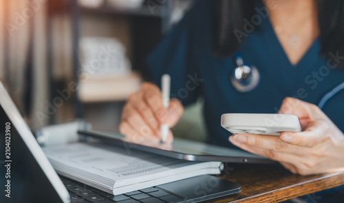 Healthcare Professional Using Tablet Stylus And Smartphone For Medical Data Entry, Telemedicine And Patient Records. Digital Health Technology Supporting Clinical Documentation And Mobile Workflow
