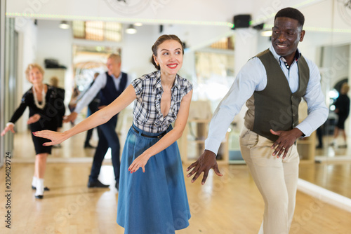 Photography Man and woman performing jazz dance in dancing room