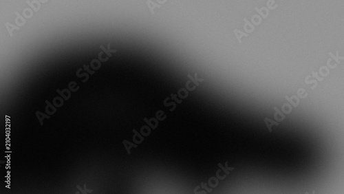 Abstract artistic composition featuring soft monochromatic gray gradients with a grainy texture and dark shadows