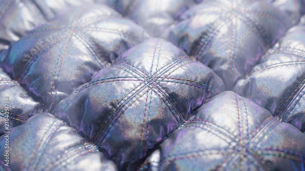 Obraz premium Quilted metallic fabric panels create a repeating geometric pattern with iridescent highlights.