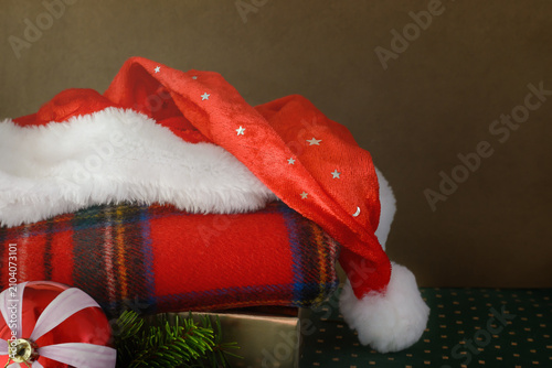 Dark beige background with Christmas red Santa hat and copy space