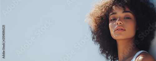 FINE ART CINEMATIC PORTRAIT OF A BEAUTIFUL YOUNG BLACK WOMAN WITH NATURAL CURLY AFRO HAIR AND EYES CLOSED IN PEACEFUL EMOTION WITH NEGATIVE SPACE