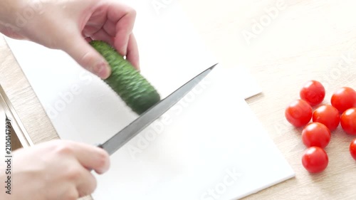 Slicing Cucumber and Cherry Tomatoes During Fresh Vegetable Preparation in Home Kitchen, 4K