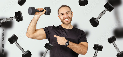 Konstfotografi Smiling Hispanic Male In His 30s Lifting Dumbbell At The Gym, Showing Strength And Fitness