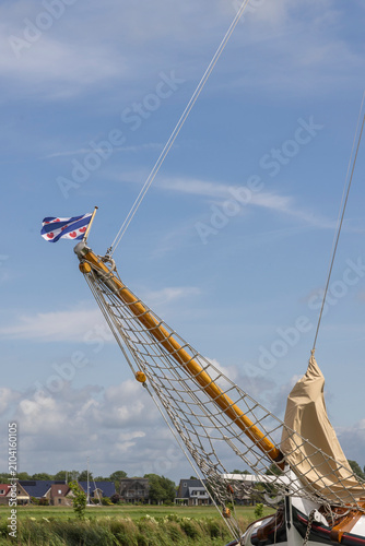 Canvas Print Traditional sailboat bowsprit with Frisian flag on a sunny day in Friesland, The
