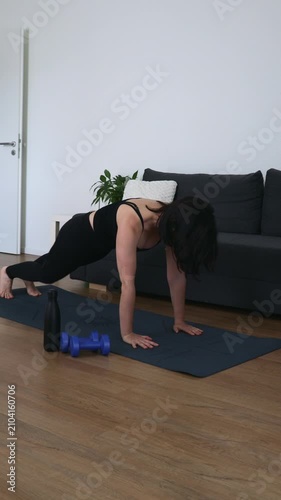 Young woman moves through child pose, plank, upward dog and downward dog on a mat at home, promoting flexibility, core strength, mobility, balance and mindful wellness.