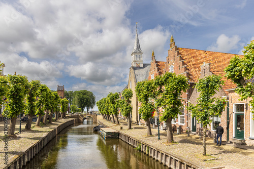 Εκτύπωση καμβά Historic canal scene with boats and church spire in Sloten, Friesland, Netherlan