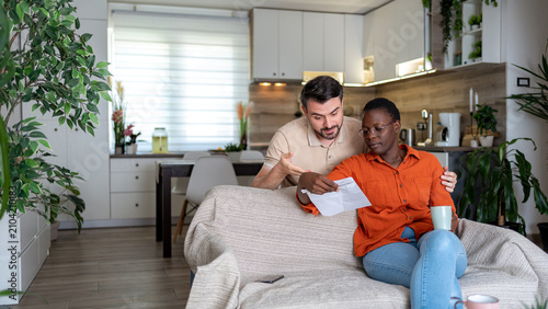 Couple discussing important matters in their home living room during the day