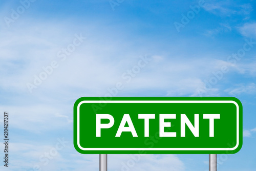 Green color transportation sign with word patent on blue sky with white cloud background