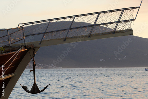 Photography Bowsprit and Hanging Anchor of a Wooden Sailing Ship Against the Sea and Mountai