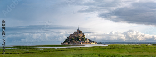 Bild auf Leinwand Road to Mont-Saint-Michel during high tide with rising water, tidal phenomenon o
