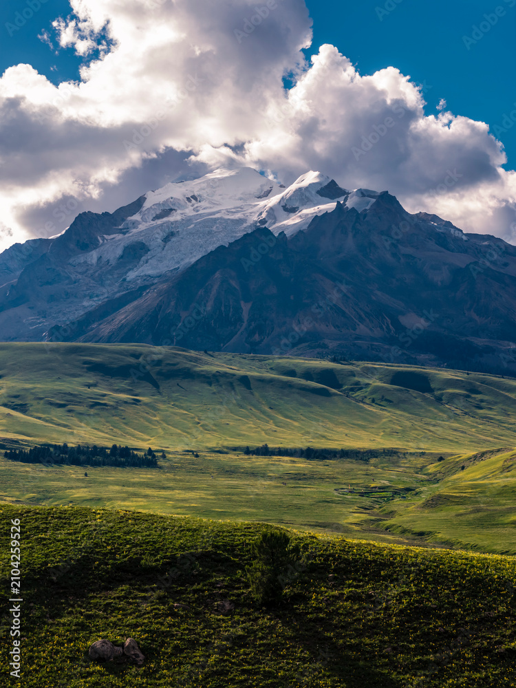 Fototapeta premium deAerial view of Genie Holy Mountain main peak, snow glacier mountain with alpine meadow and primitive forest, Hengduan Mountains natural scenery in Litang West Sichuanfault