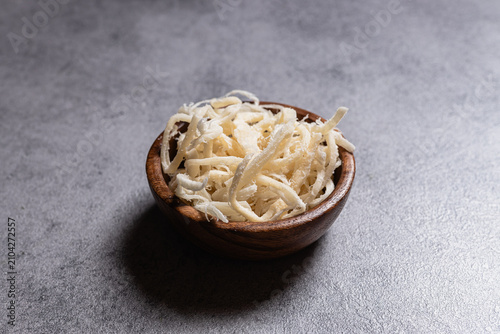 Dried Shredded Squid Served In Wooden Bowl