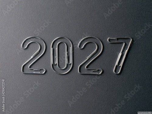 Silver paperclips form the numbers 2027 on a dark gray, textured background
