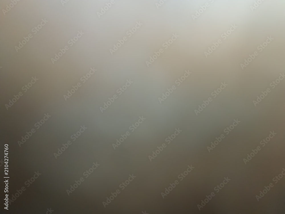 Obraz premium Abstract moody warm grey and beige blurred background with soft smoky texture and vintage fine art studio portrait lighting effect.