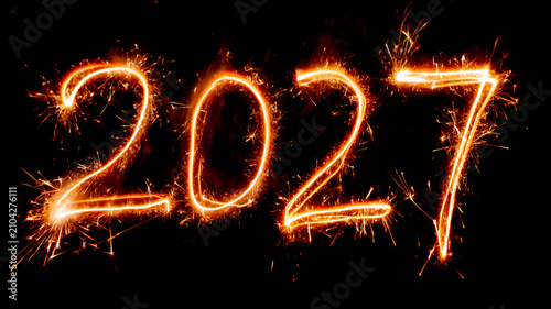 Glowing 2027 sparkler numbers on a black background, festive New Year celebration concept with bright fireworks and copy space