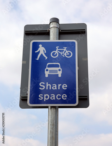 Share Space sign on a blue background against clear sky