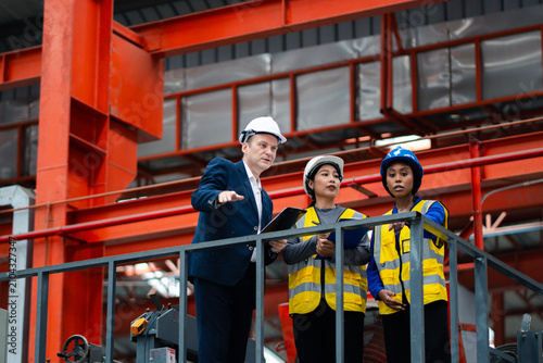 Industrial leadership and factory inspection. Engineers and managers review production operations on a manufacturing platform. Leadership, inspection, industry, teamwork, manufacturing