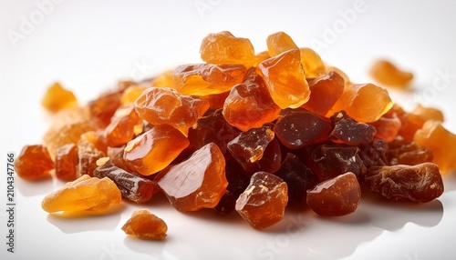 Close Up Of Benzoin Resin Fragments With Warm Tones Against A Clean White Backdrop