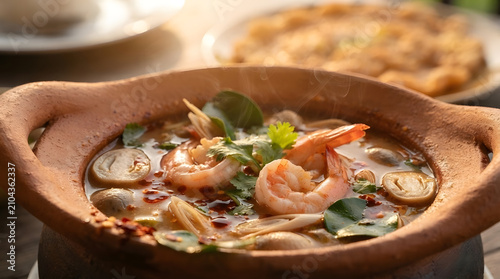 Authentic Thai spicy shrimp soup in clay pot, creative food art illustration