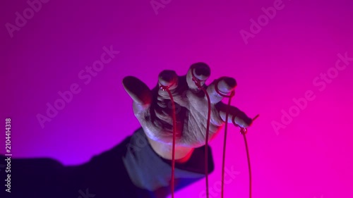 Hand with Puppet Strings in Neon Pink Light — Control and Manipulation Concept