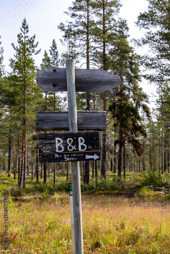Canvas Print Idre, Sweden A wooden B and B sign on a rural forest road.