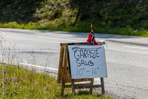 Billede på lærred Drevsjo, Norway A sign in Norwegian on a road with a Norwegian flag advertises a