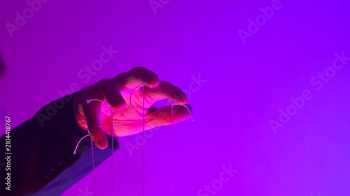 Hand with Puppet Strings in Neon Pink Light — Control and Manipulation Concept