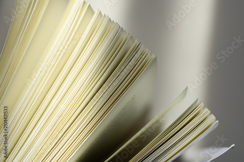 Konstfotografi Close-up of open book pages with soft lighting,Macro,A detailed close-up shot of the white pages of an open book, captured with soft, elegant lighting to emphasize texture and minimalist aesthetic