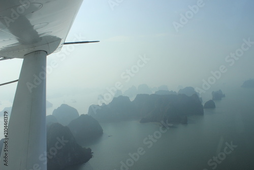 Aerial view of halong bay vietnam from small aircraft window during sunny morning.