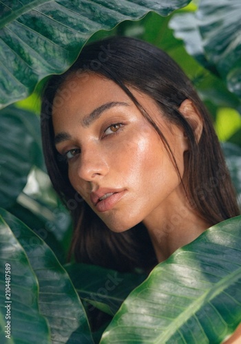 Natural Beauty Portrait of Woman Surrounded by Tropical Green Leaves