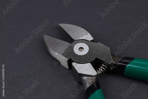 Fotografie nipper diagonal cutting pliers on dark background.
