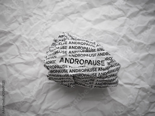 Fotografía Crumpled paper ball with words Andropause on a crumpled white paper background