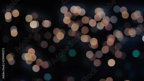 Abstract Defocused City Lights Bokeh Background at Night with Warm Glowing Circular Light Orbs and Dark Urban Blurred Backdrop
