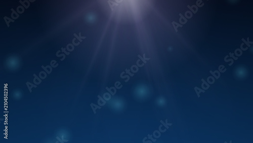 Underwater sunlight rays and bubbles deep blue ocean abstract background