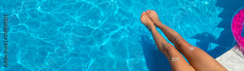Photos Sunscreen on child legs. Selective focus.