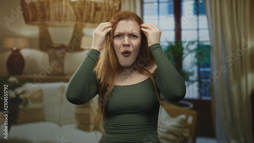 Cuadro en lienzo Woman raising hands with open mouth shouting in building interior living room; frustration disbelief