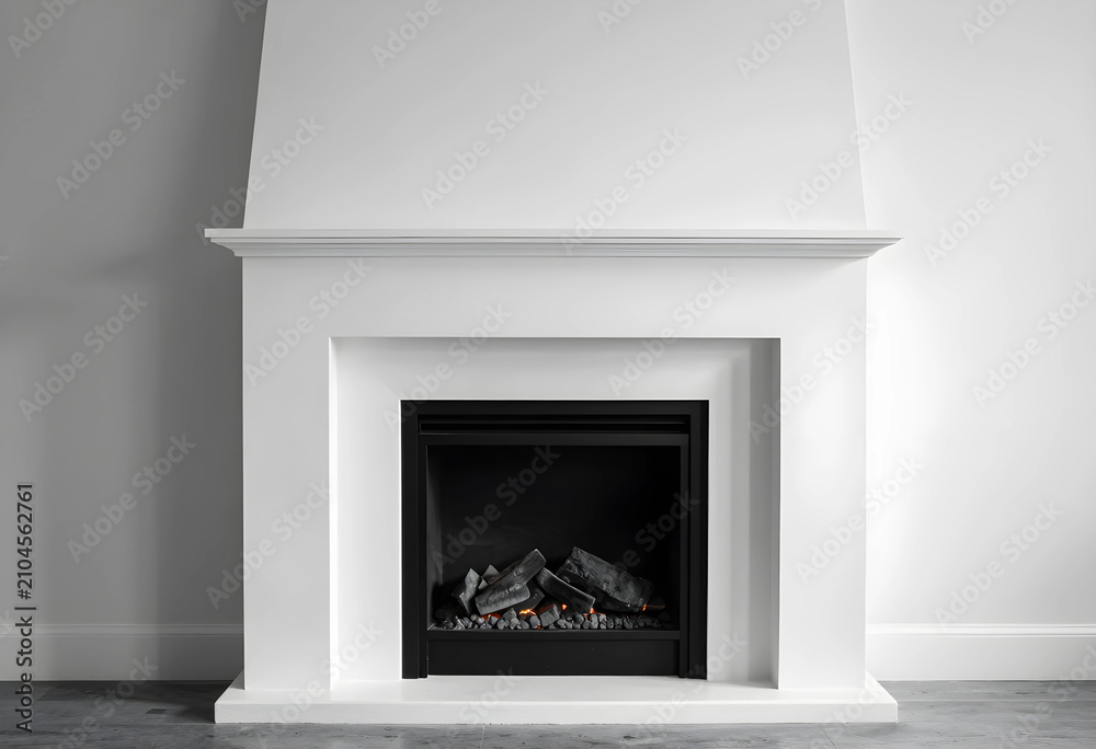 Obraz premium Modern white fireplace with a minimalist design and gas logs, home interior architecture and renovation