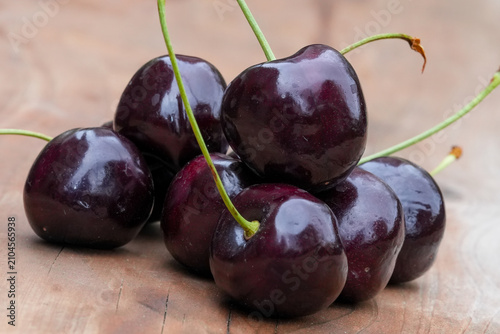 Konstfotografi Close-up of a Pile of Dark Red English Morello cherries, Prunus ceruss, on a Rus