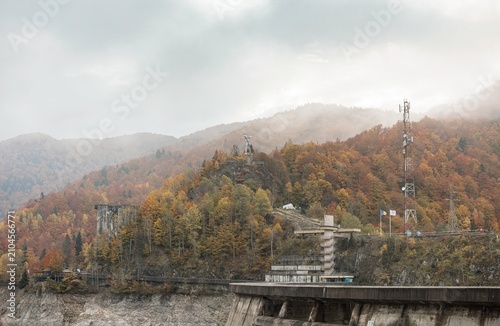 Konstfotografi Springing from nature’s embrace, the dry Vidraru lake showcases remnants of past