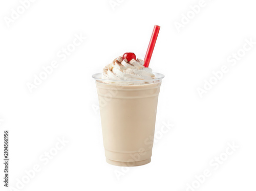 Creamy vanilla milkshake in a plastic cup with whipped cream and a red straw