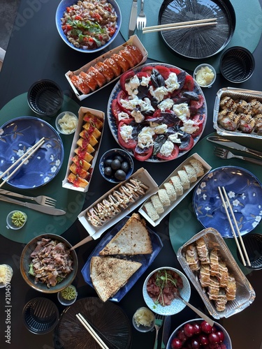 Japanese Sushi Feast with Rolls Salad and Appetizers Served on Dining Table