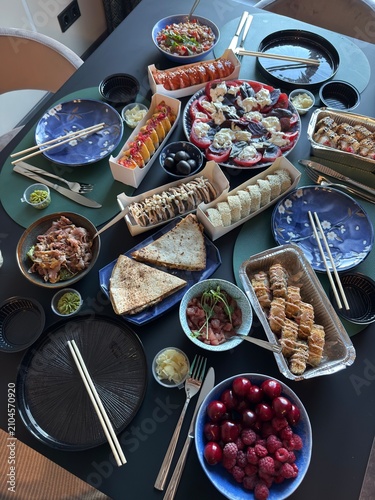 Japanese Sushi Feast with Rolls Salad and Appetizers Served on Dining Table