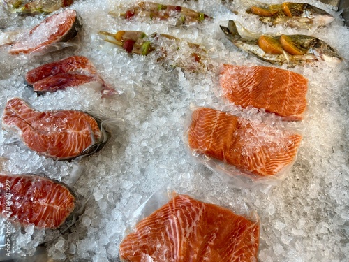 Fresh Seafood Display with Salmon Fish and Ice at Fish Market