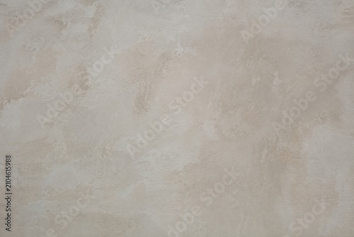 Beige Plaster Wall Texture. Neutral mottled stone backdrop evoking calm minimalism through an organic hand applied finish that offers a subtle timeless serenity.