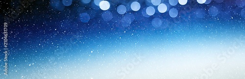 Soft blue bokeh lights and tiny white specks cascade across a gradient