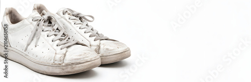 worn white sneakers on white background studio shot