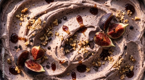 Close up texture of fig ice cream with fresh fig slices, crushed walnuts and caramel drizzle