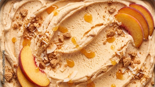 Close up texture of peach ice cream with fresh fruit slices, biscuit crumbs and coconut flakes